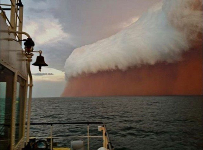 This giant mug of beer in the distance is actually a sand storm in Australia. 