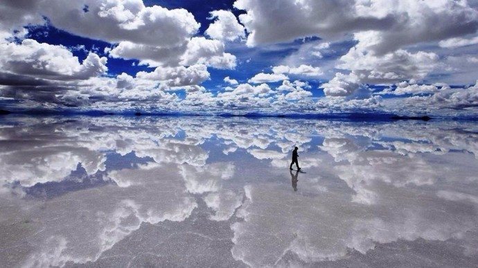 It looks like he walks on water, but these actually are giant salt flats in Bolivia. 