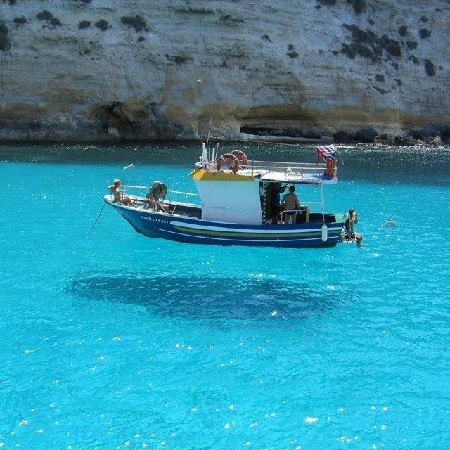 This boat may look like flying, but it is just its reflection in very clear water. 