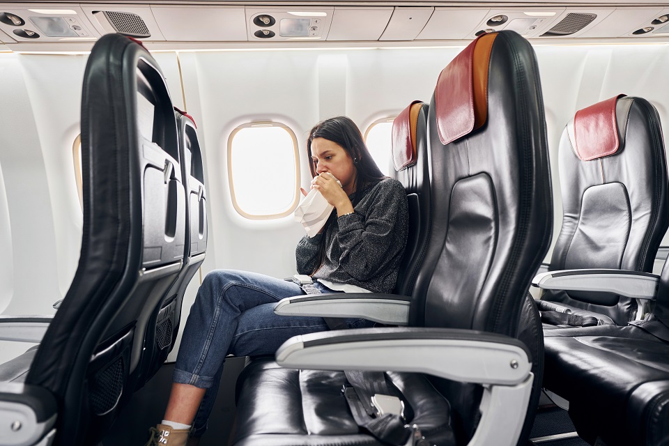 woman feeling sick on plane